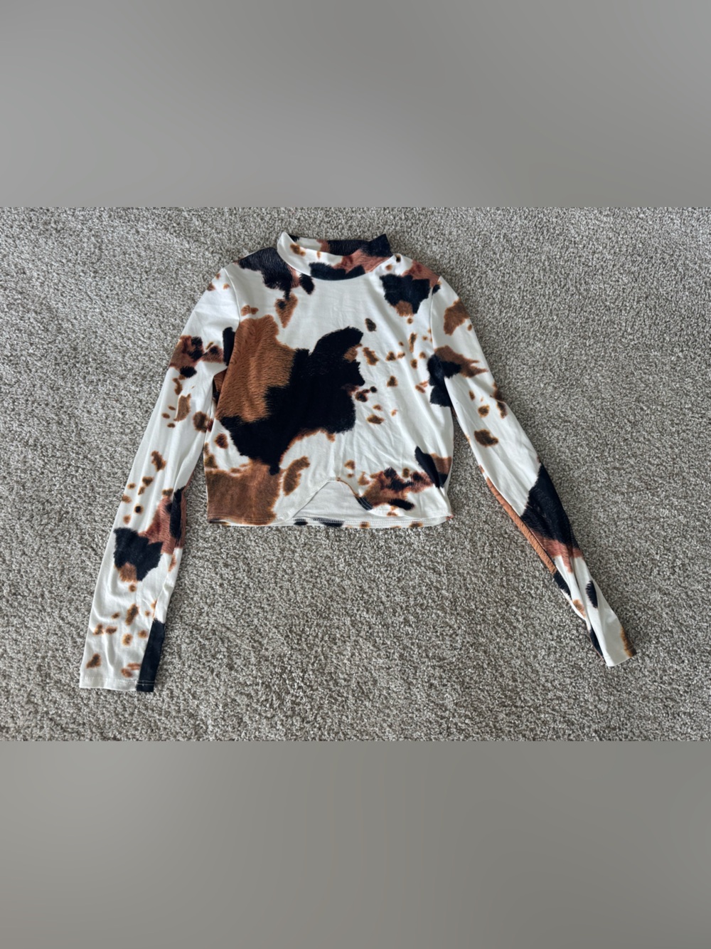 Willow Boutique: 
long-sleeved cropped cow print top